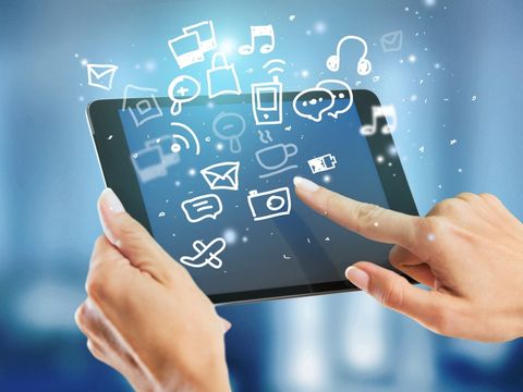 Tablet mit fliegenden Symbolen